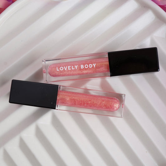 Two lip glosses with 'Lovely Body' branding on a white surface.